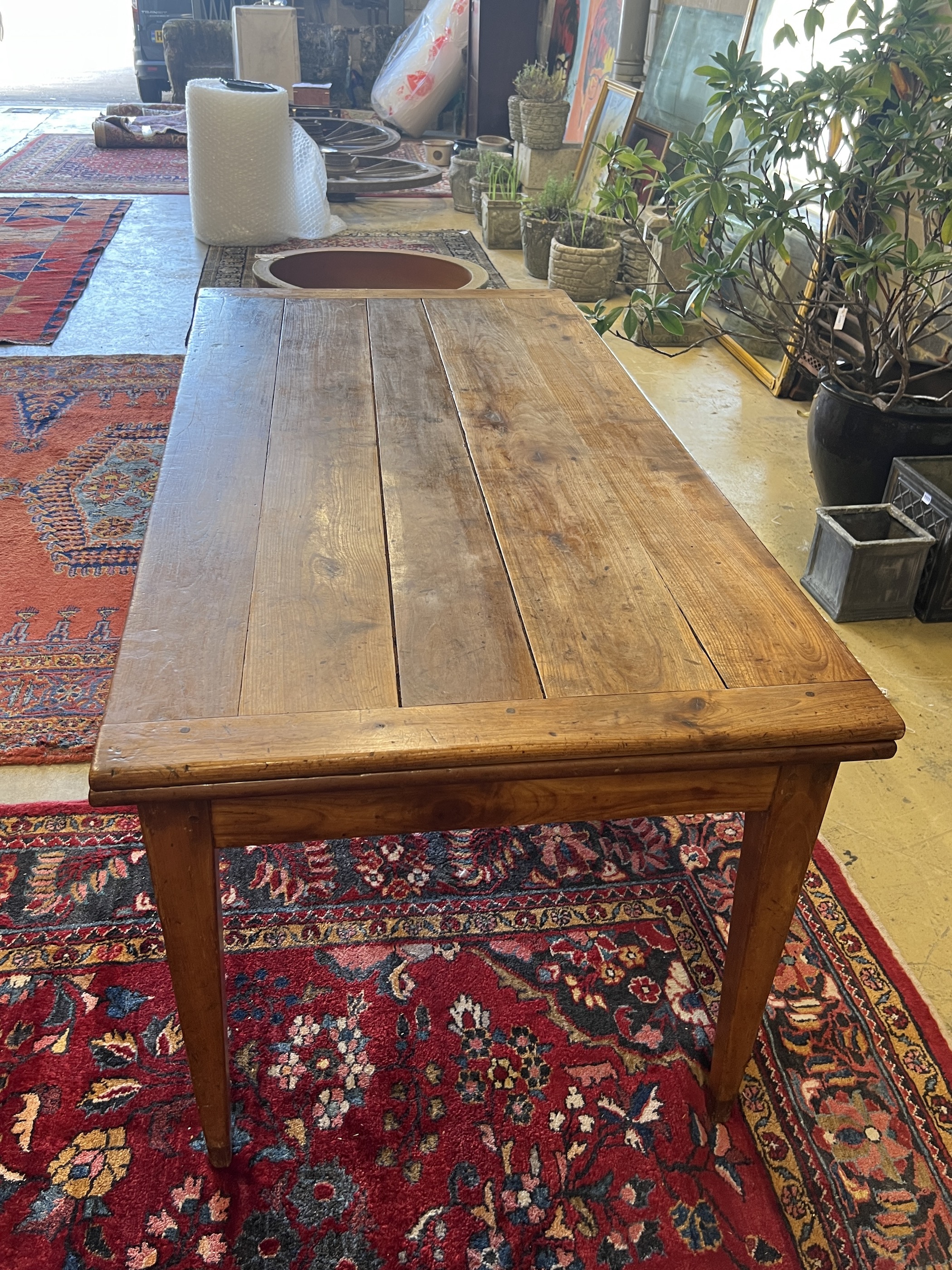 A 19th century French cherry farmhouse table with single extension on square tapered legs, width 166cm, (232cm extended) depth 82cm, height 73cm
